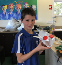 Grade 4 student Oliver with his artwork